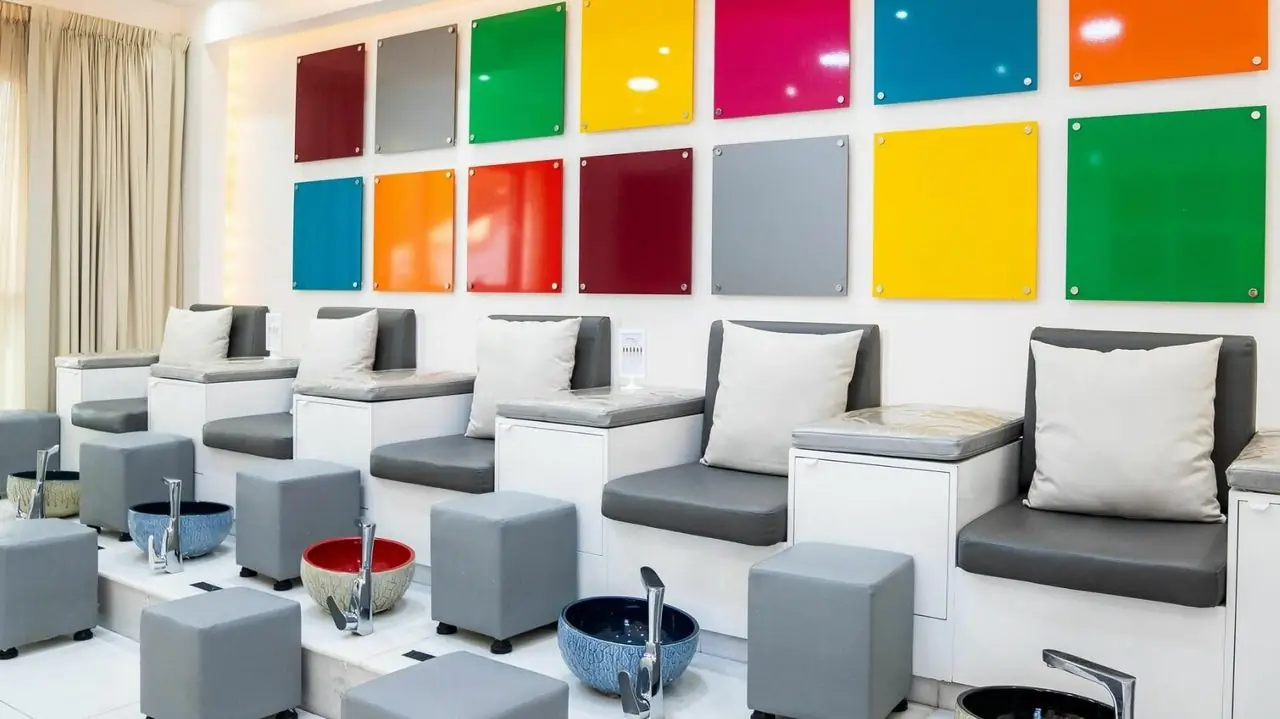 The pedicure lounge at Color Me Spa, with its wall of colour tiles